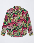A long-sleeve button-up shirt with a vibrant, hand-drawn style abstract pattern in pink, green, yellow, and black, laid flat against a light gray background.