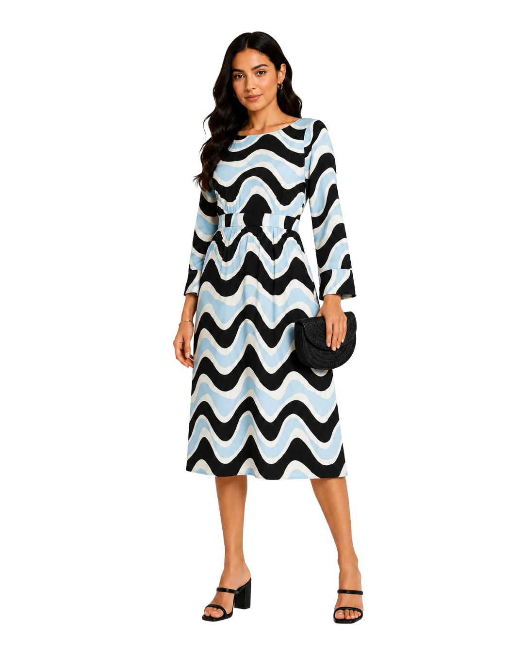 A woman modeling a knee-length dress with a bold black, white, and light blue wavy pattern, holding a black clutch purse and wearing black heeled sandals against a plain white background.
