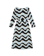 A long-sleeve midi dress with a wavy, zig-zag pattern in black, light blue, and cream,  shown against a plain white background.