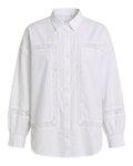 A white long-sleeve button-up shirt with decorative white lace trim outlining the chest pockets and cuffs, shown against a plain white background.