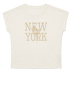 An off-white short-sleeve crop top featuring a distressed tan graphic that reads 'NEW YORK' with a rooster illustration in the center, displayed on a clean white background.