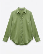 An olive green long-sleeve button-up shirt with a pointed collar, displayed flat against a light gray background.