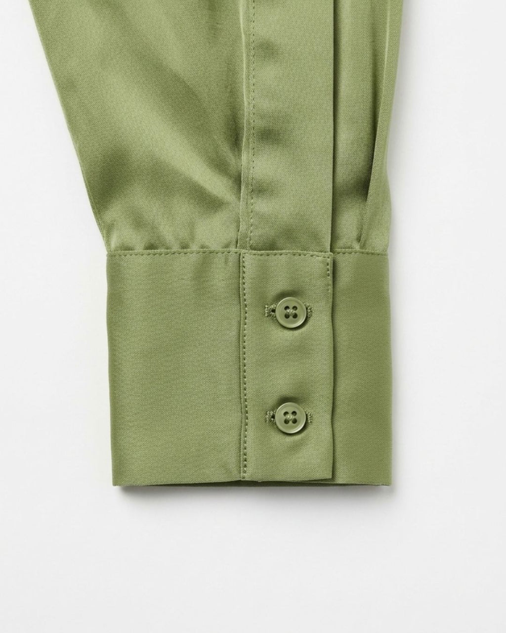 Close-up of a sage green long-sleeve shirt cuff with two button closures, shown on a clean white background.
