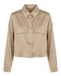 A cropped long-sleeve button-up shirt in a light beige or khaki color, featuring a pointed collar, button front, and two flap chest pockets, shown against a plain white background.