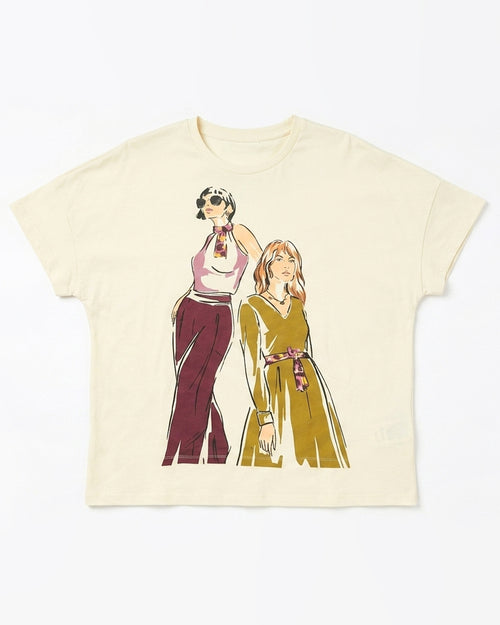 An off-white short-sleeve t-shirt featuring a graphic print of two retro-style illustrated women, one in a pink and maroon outfit and the other in a yellow-green dress, both wearing patterned neckties.