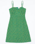 A green sleeveless dress with thin shoulder straps and an allover yellow geometric pattern, shown flat against a white background.