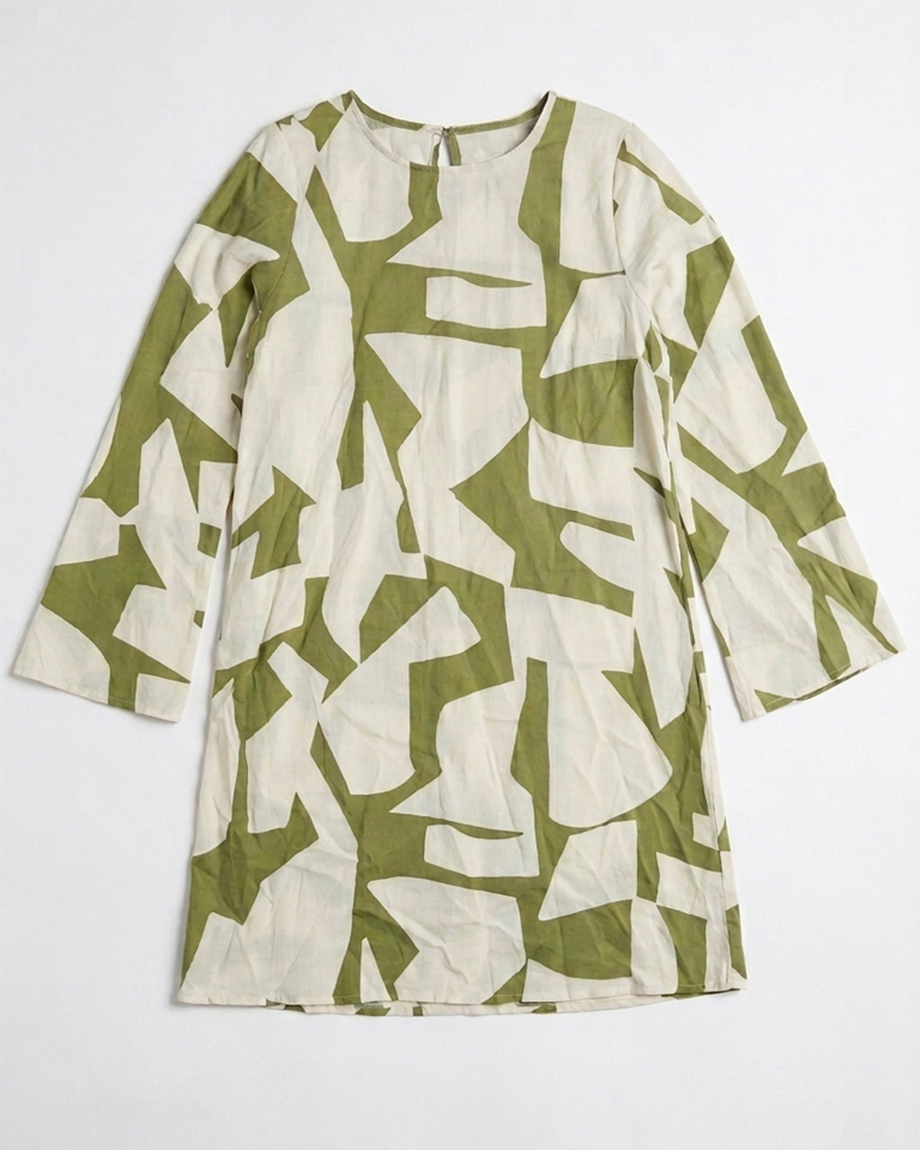 A long-sleeve tunic dress with an abstract geometric print in olive green and cream, laid flat against a light gray background.