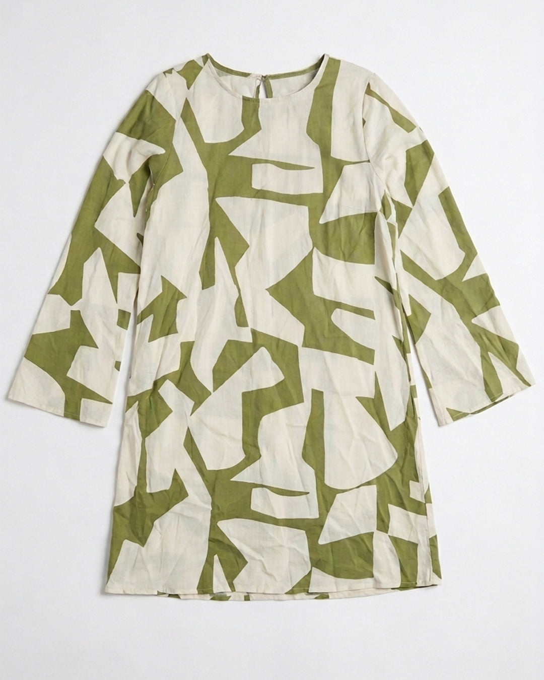 A long-sleeve tunic dress with an abstract geometric print in olive green and cream, laid flat against a light gray background.
