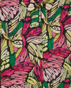 A close-up of a button-front shirt with an all-over butterfly and leaf print in bright pink, green, yellow, and black.